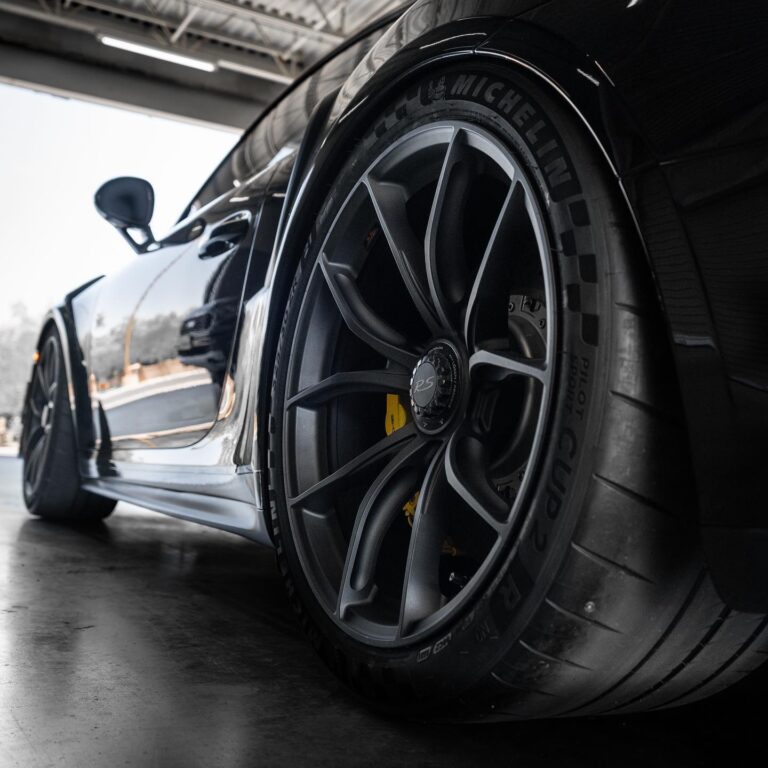 Black multi-spoke alloy wheel on a sports car