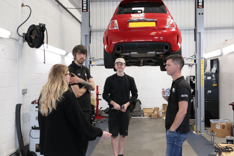 The team around a car on the lift