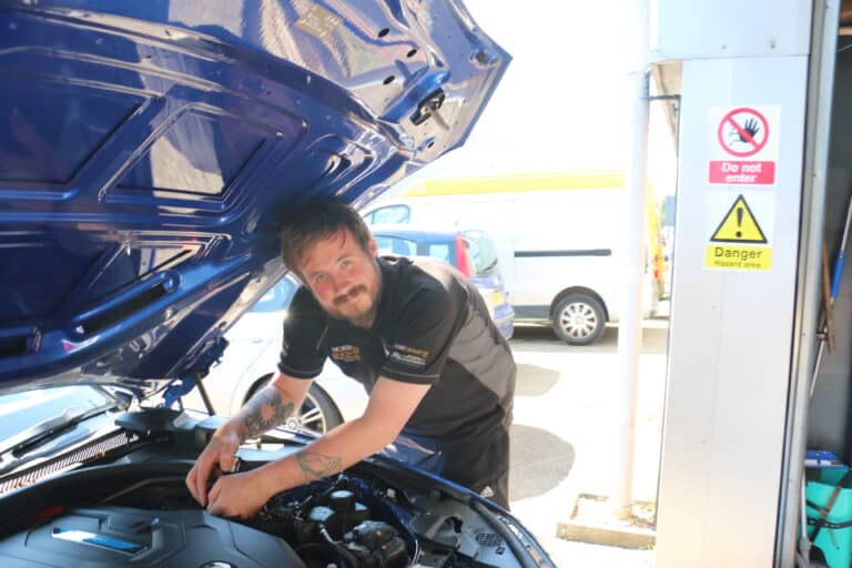 A technician working in the engine bay