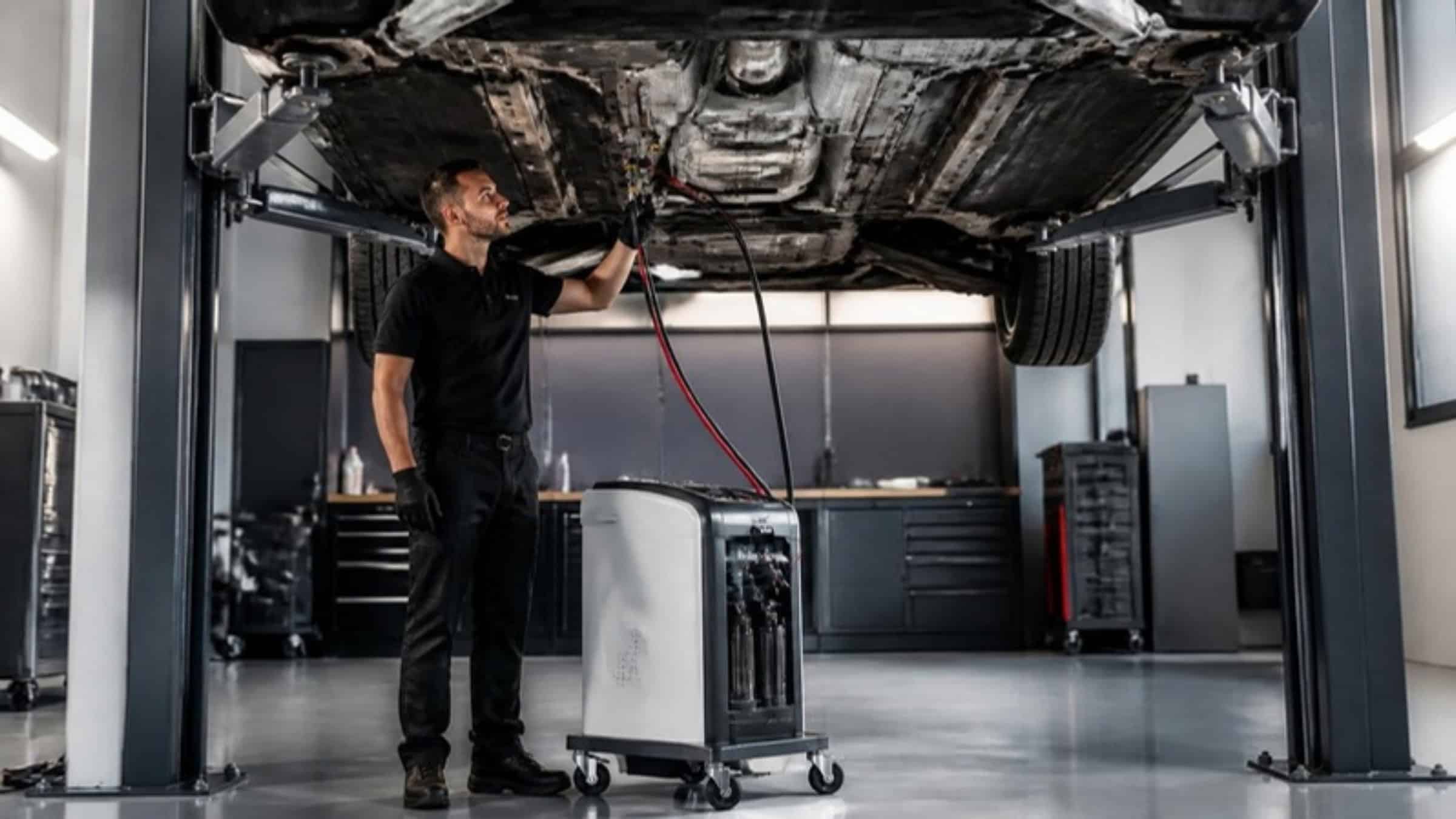 Automatic gearbox oil exchange machine connected under a car on a lift